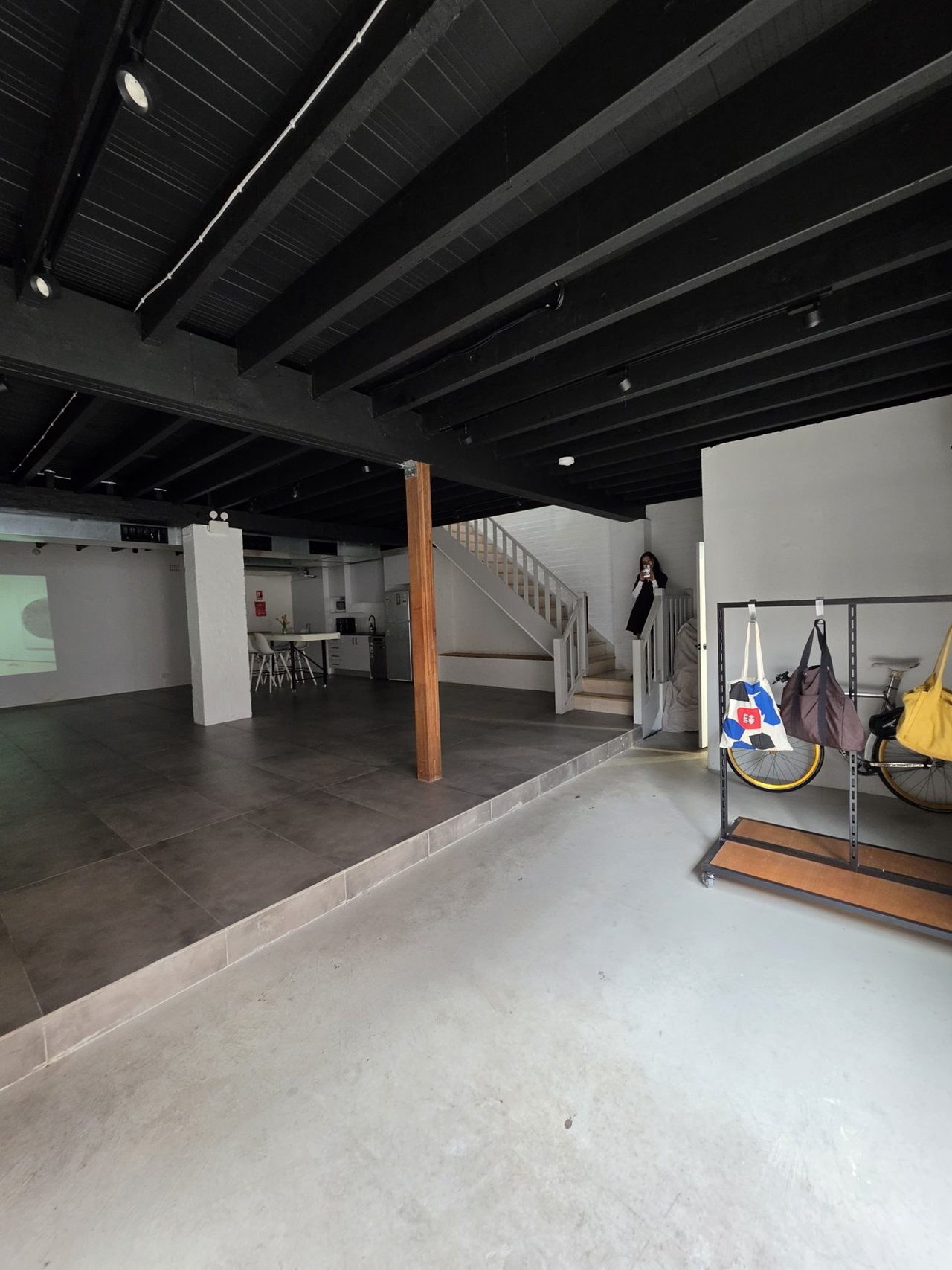 The entry corner from the platform — coat racks, bike parking, the door beyond.