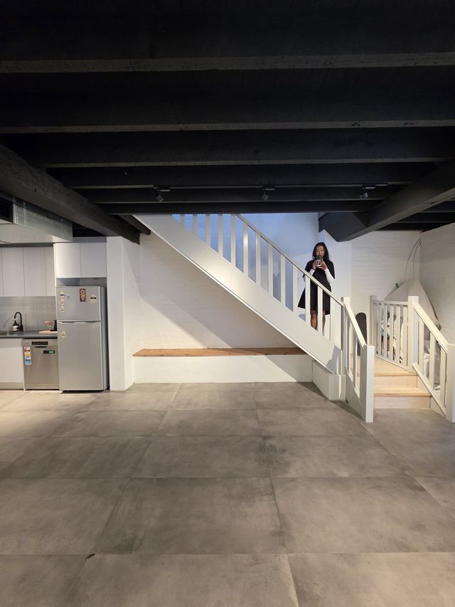 The staircase up to the loft, kitchen alongside.