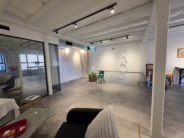 The backdrop end of the loft, couch corner and exit to the stairs.